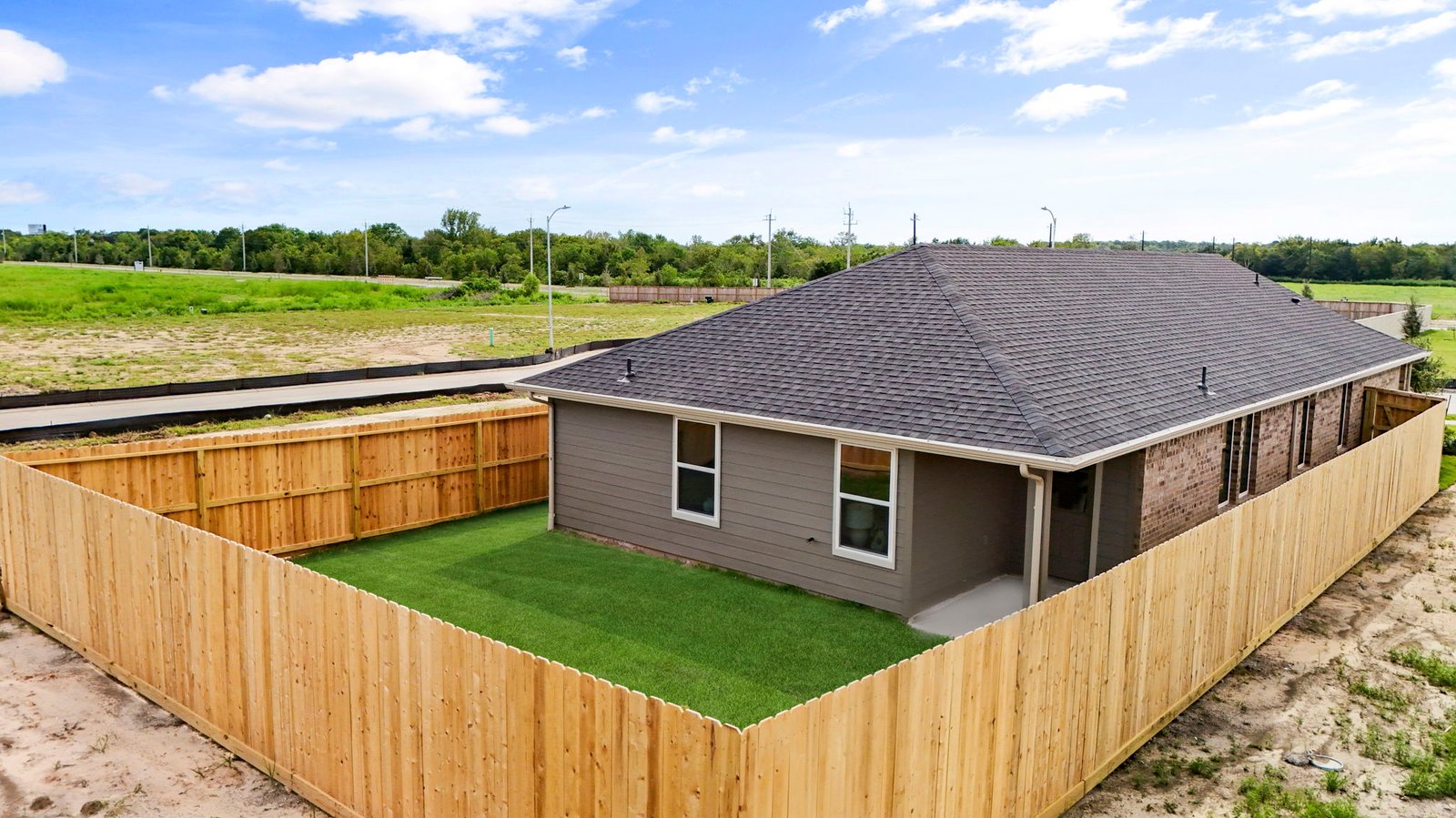 Aerial view of the backyard with a fence surrounding