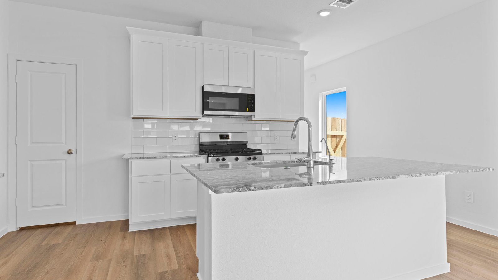Kitchen adorned with painted cabinets seamlessly integrated into an open dining area layout.