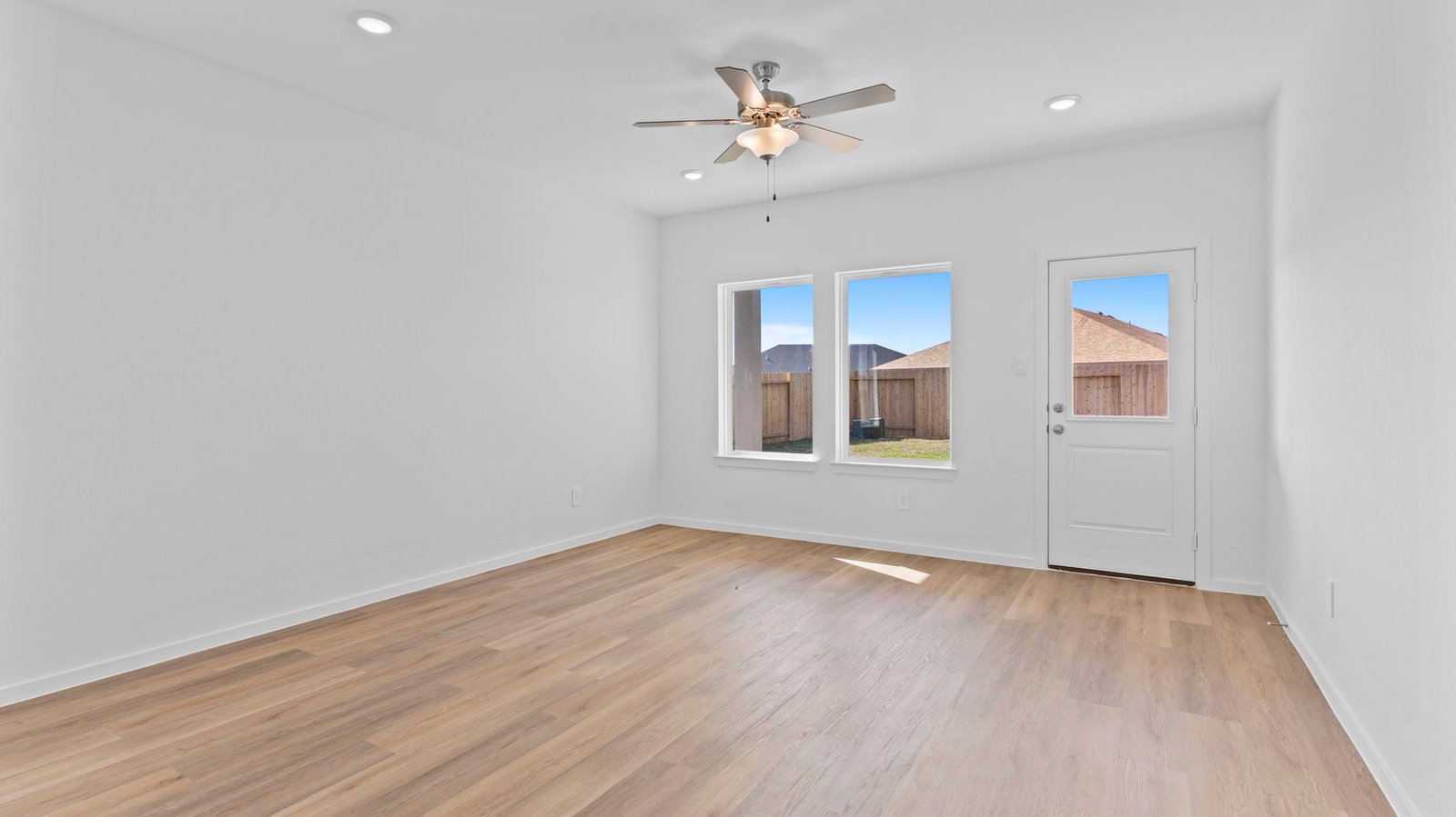 A well-organized living room that includes a kitchen and dining area, creating a warm and welcoming environment for gatherings.