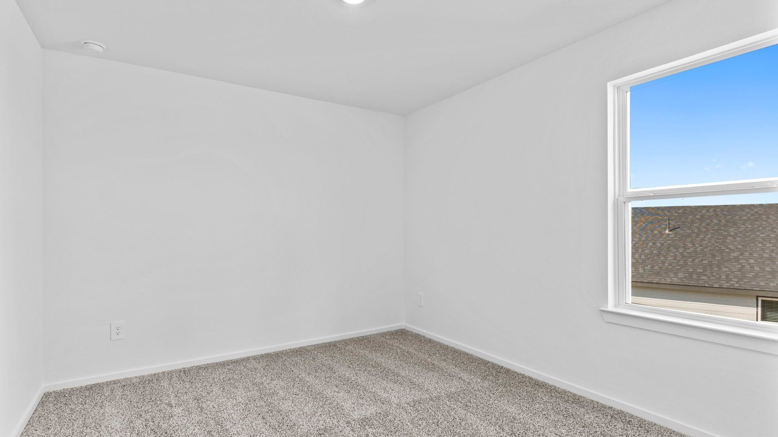 A third bedroom with neutral walls, plush carpet flooring and a separate closet.