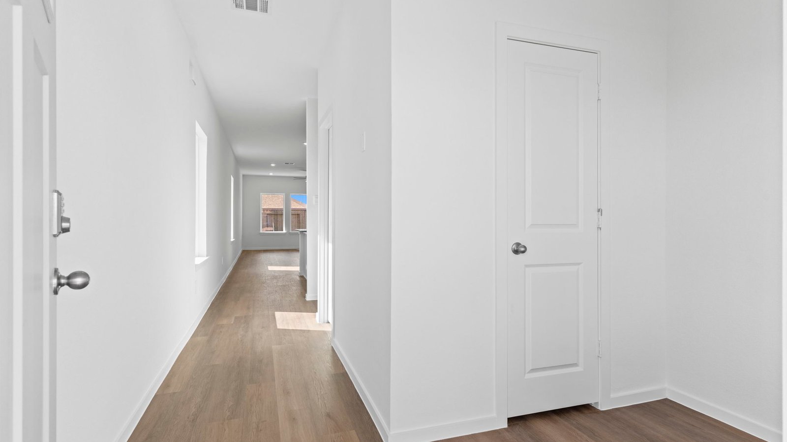 Entry hallway leading to living room and kitchen in the background.