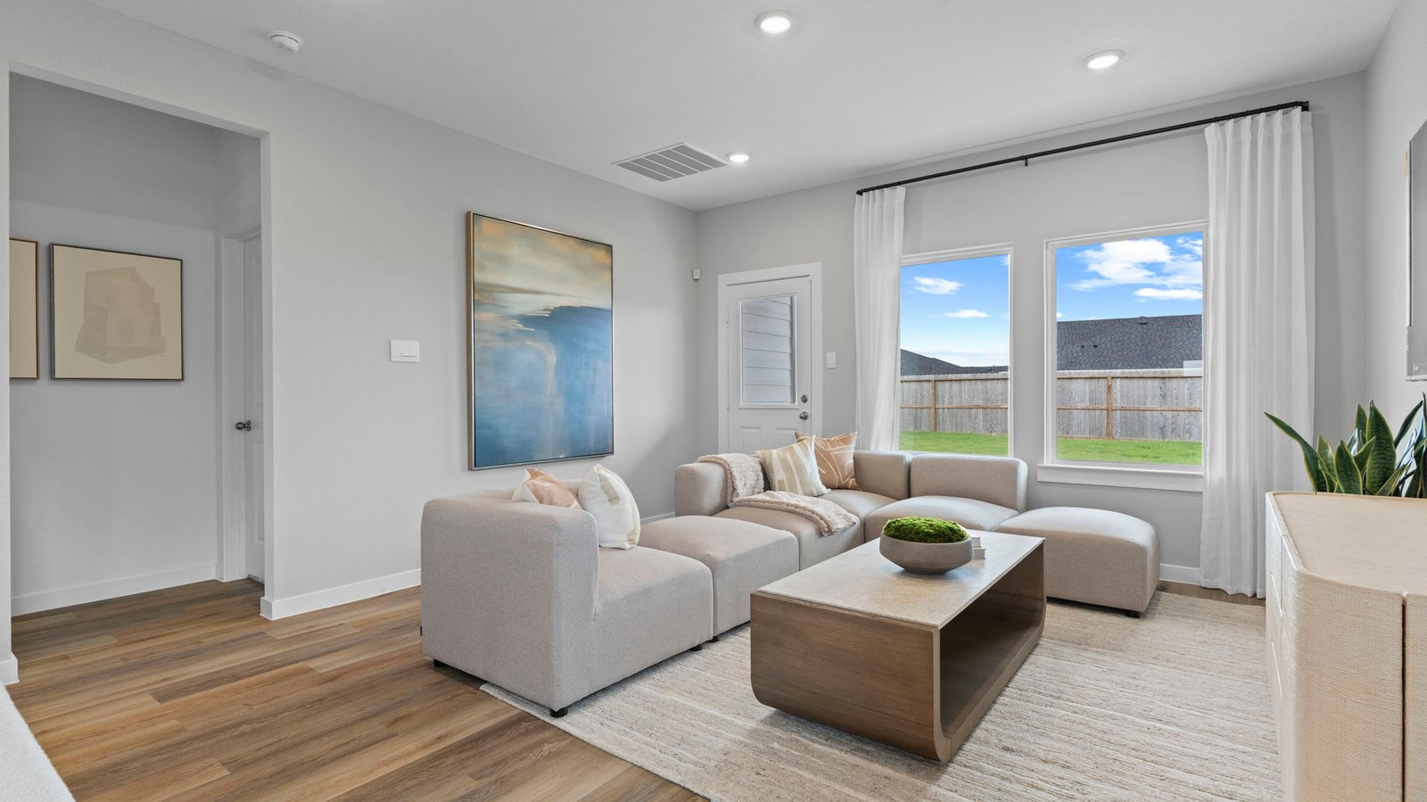 A well-organized living room that includes a kitchen and dining area, creating a warm and welcoming environment for gatherings.