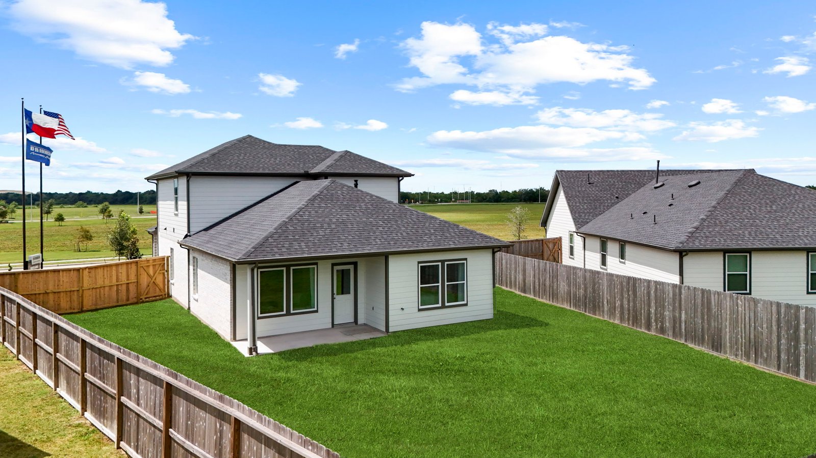 Large fenced-in backyard with a covered patio, perfect for outdoor entertaining.