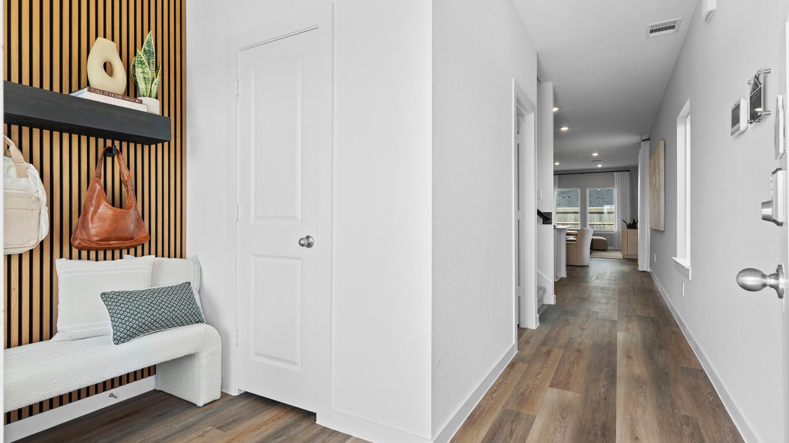 Entry hallway leading to living room and kitchen in the background.