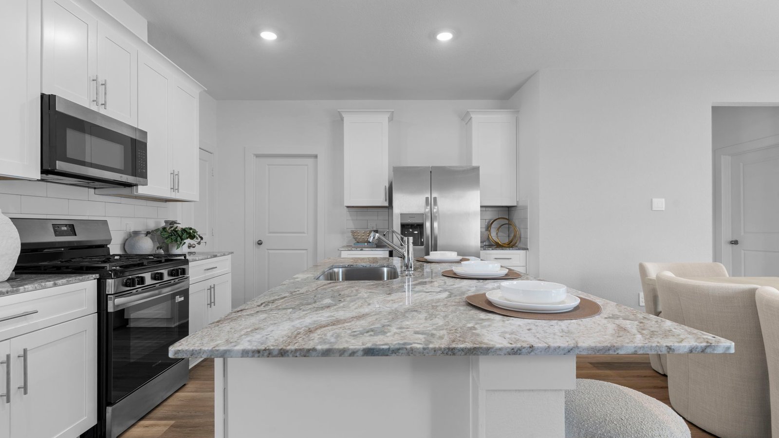 open concept kitchen with large island and walk in pantry