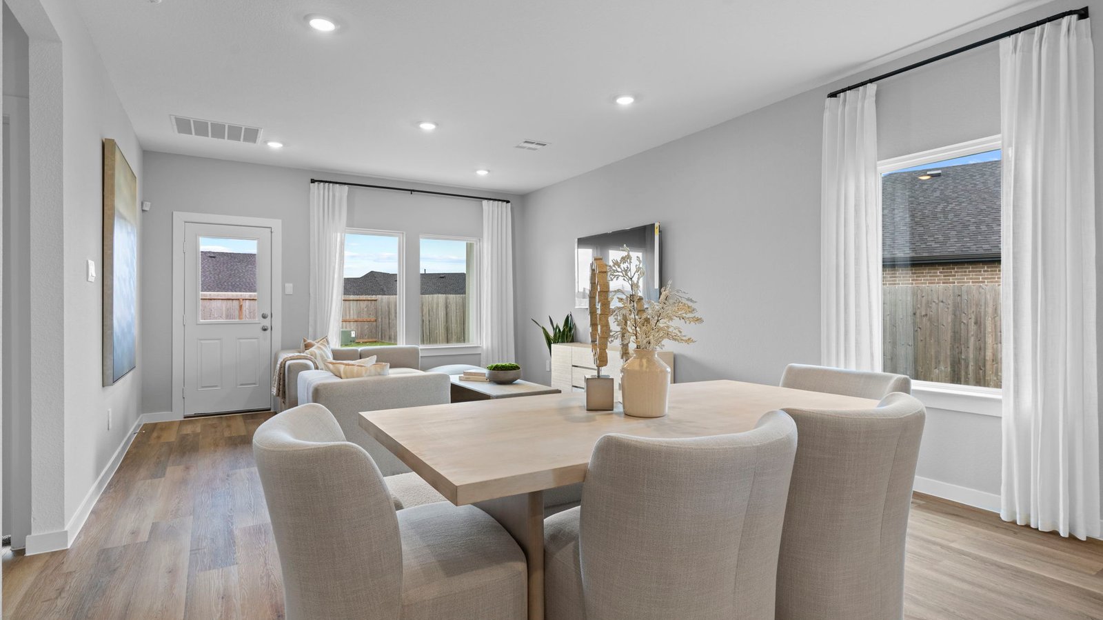 Spacious open concept dining area with vinyl wood flooring and access to the living and kitchen areas