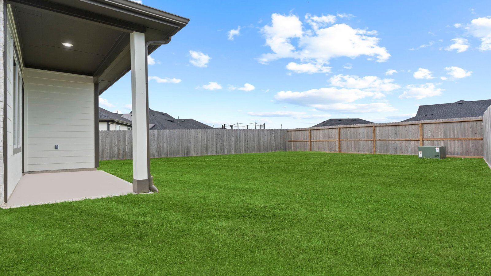 Large fenced-in backyard with a covered patio, perfect for outdoor entertaining.