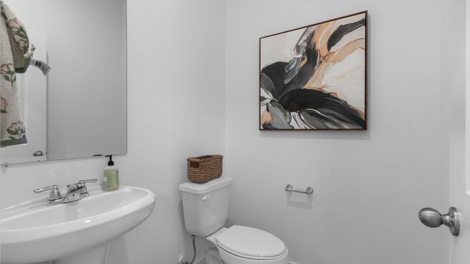 A decorated half bathroom downstairs for guests