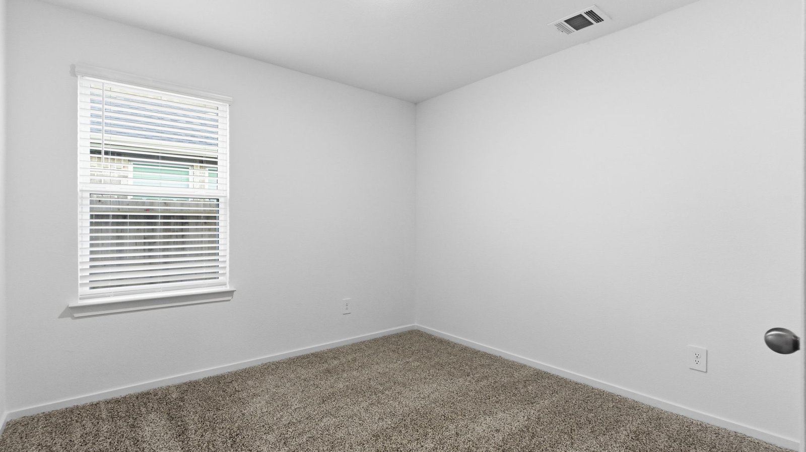 A third bedroom with neutral walls, plush carpet flooring and a separate closet.