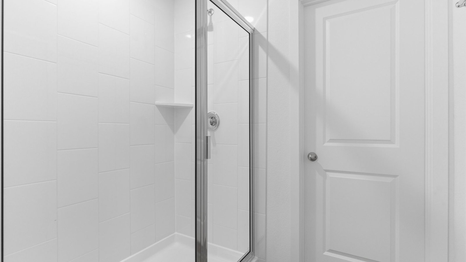 Primary bathroom with a glass-enclosed standing shower and separate soaking tub.