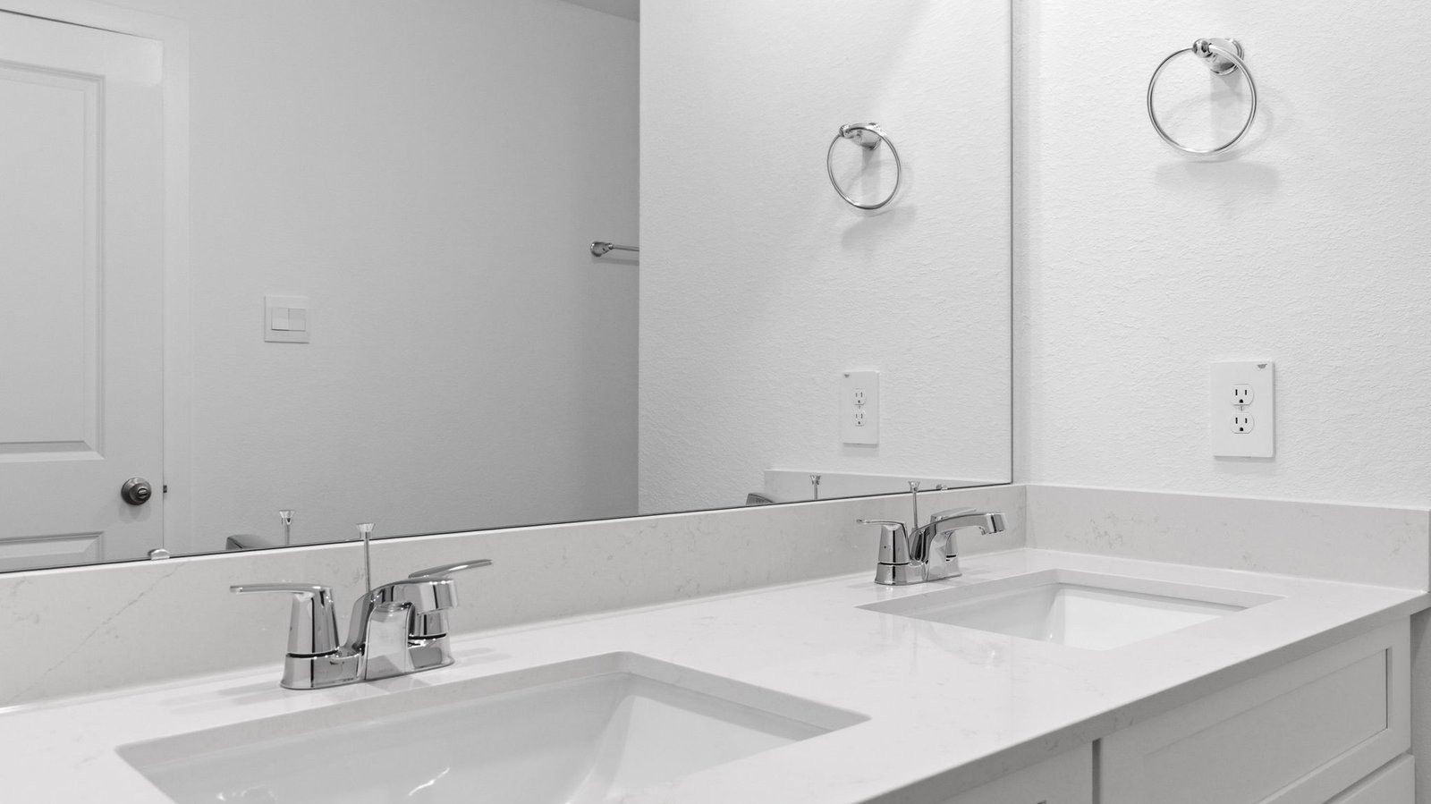 Modern primary bathroom with double vanities
