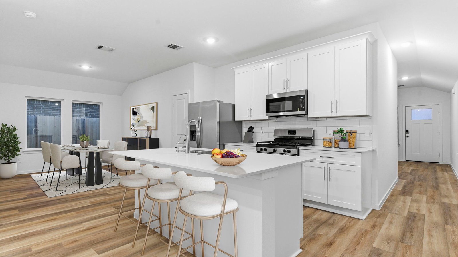 Kitchen adorned with painted cabinets seamlessly integrated into an open dining area layout.