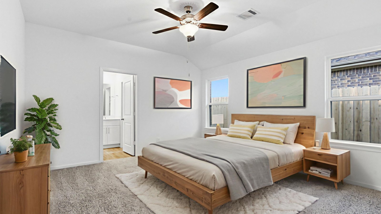 A spacious primary bedroom emphasizing open space and natural lighting with large windows.