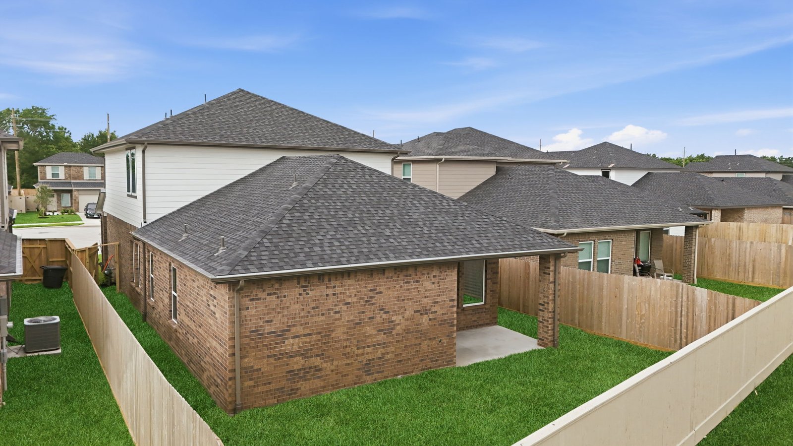 Large fenced-in backyard with a covered patio, perfect for outdoor entertaining.