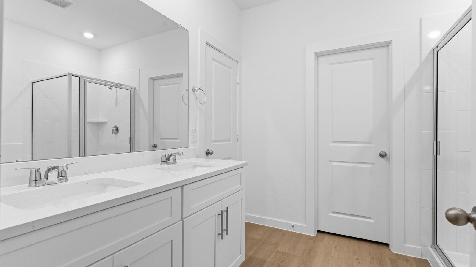 Primary bathroom with a glass-enclosed standing shower and separate soaking tub.