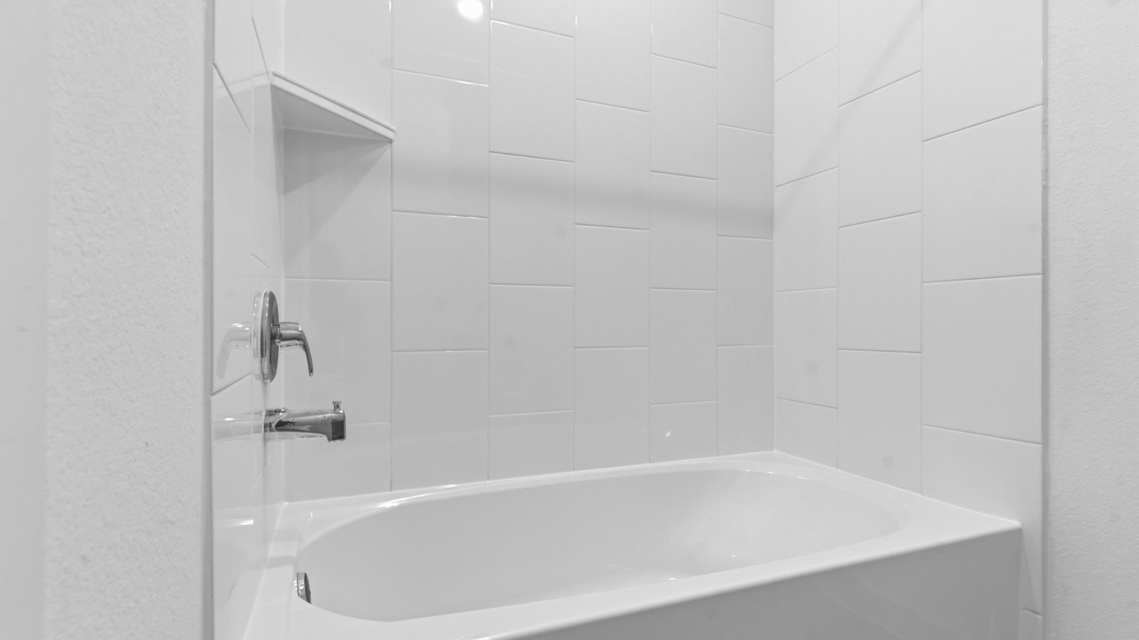 A well-designed bathroom equipped with quartz countertops, a standing tub, and a single vanity.