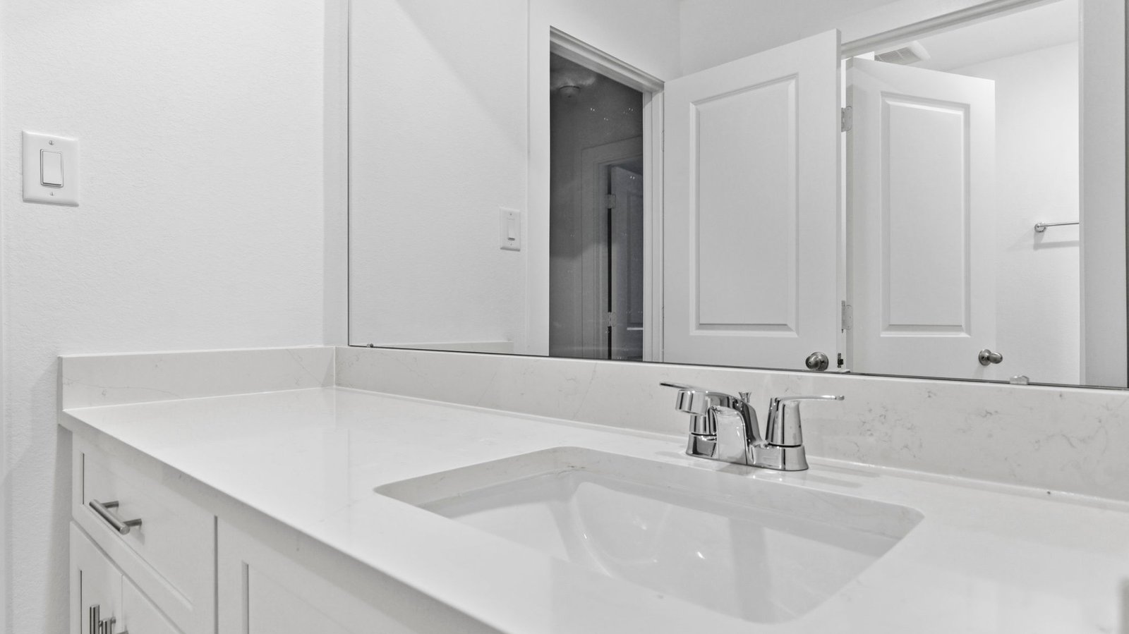 A well-designed bathroom equipped with quartz countertops, a standing tub, and a single vanity.