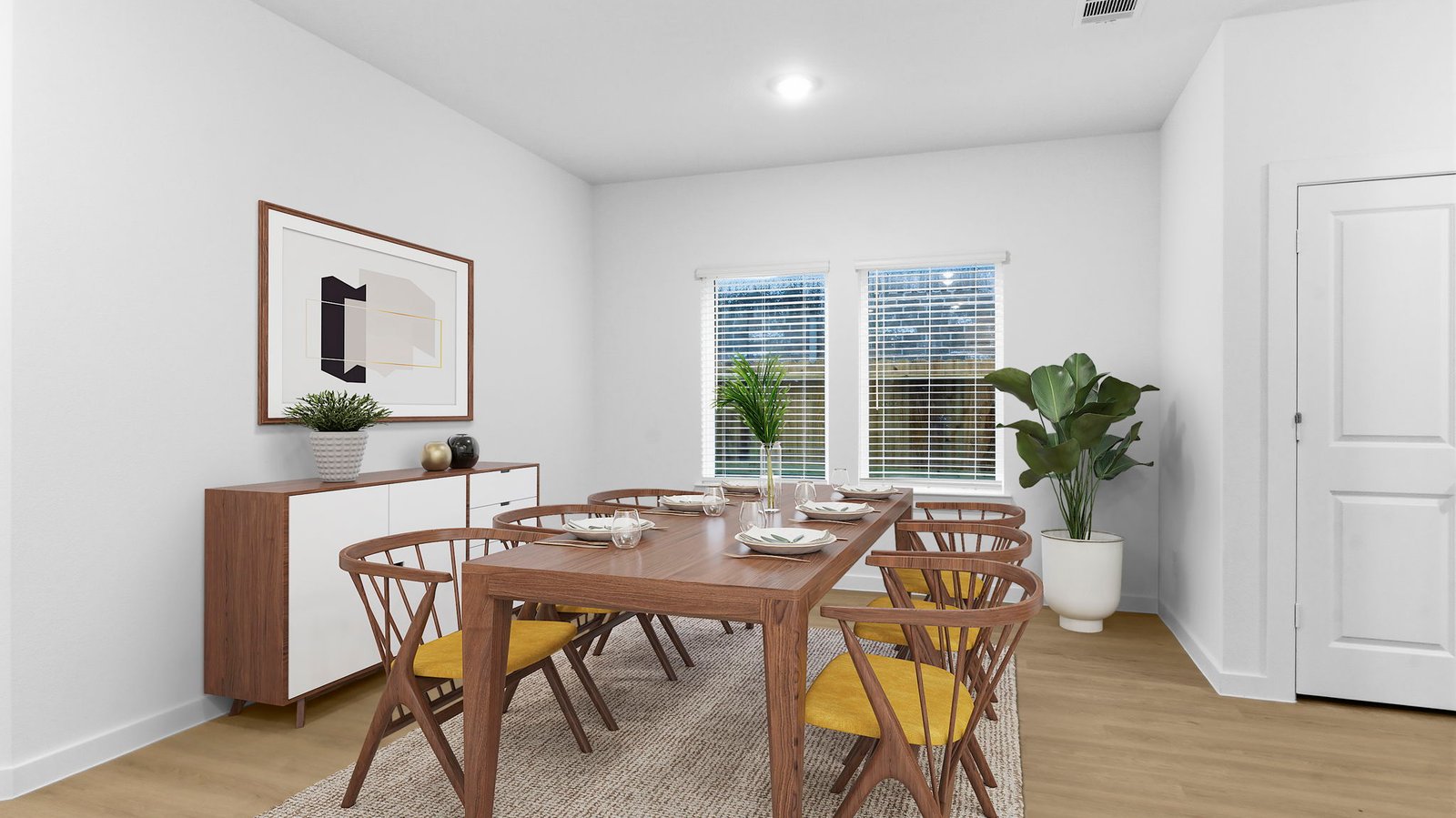 Formal dining area with large windows, vinyl wood floors, and view of the backyard.