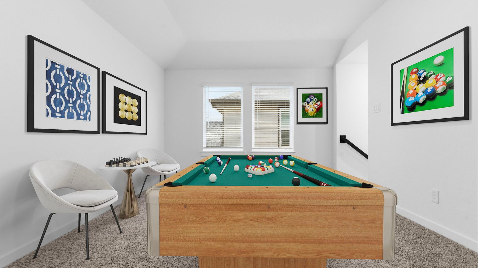 A spacious upstairs game room with plenty of natural light from windows overlooking side of the home