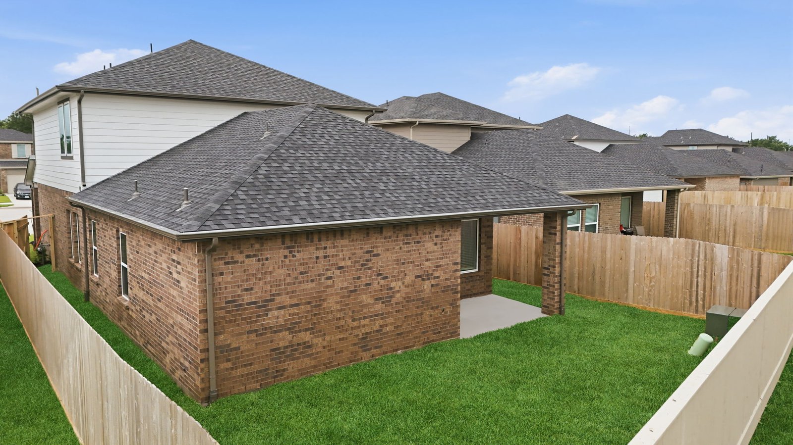 Large fenced-in backyard with a covered patio, perfect for outdoor entertaining.