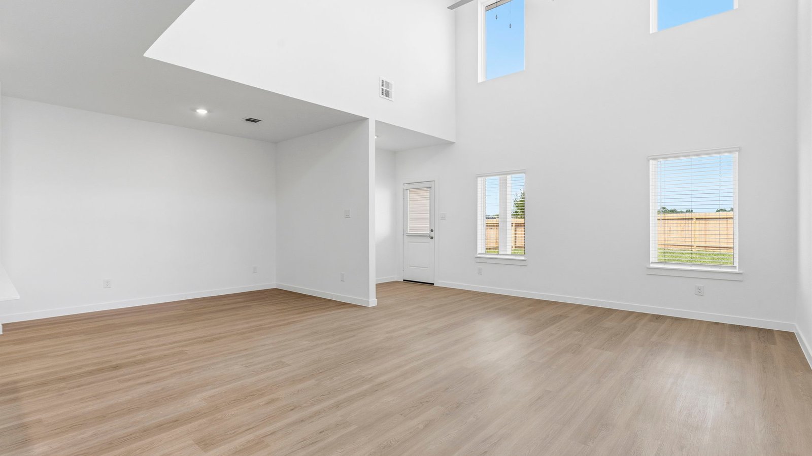 An open concept kitchen with an island with bar seating and access to the living and dining areas.