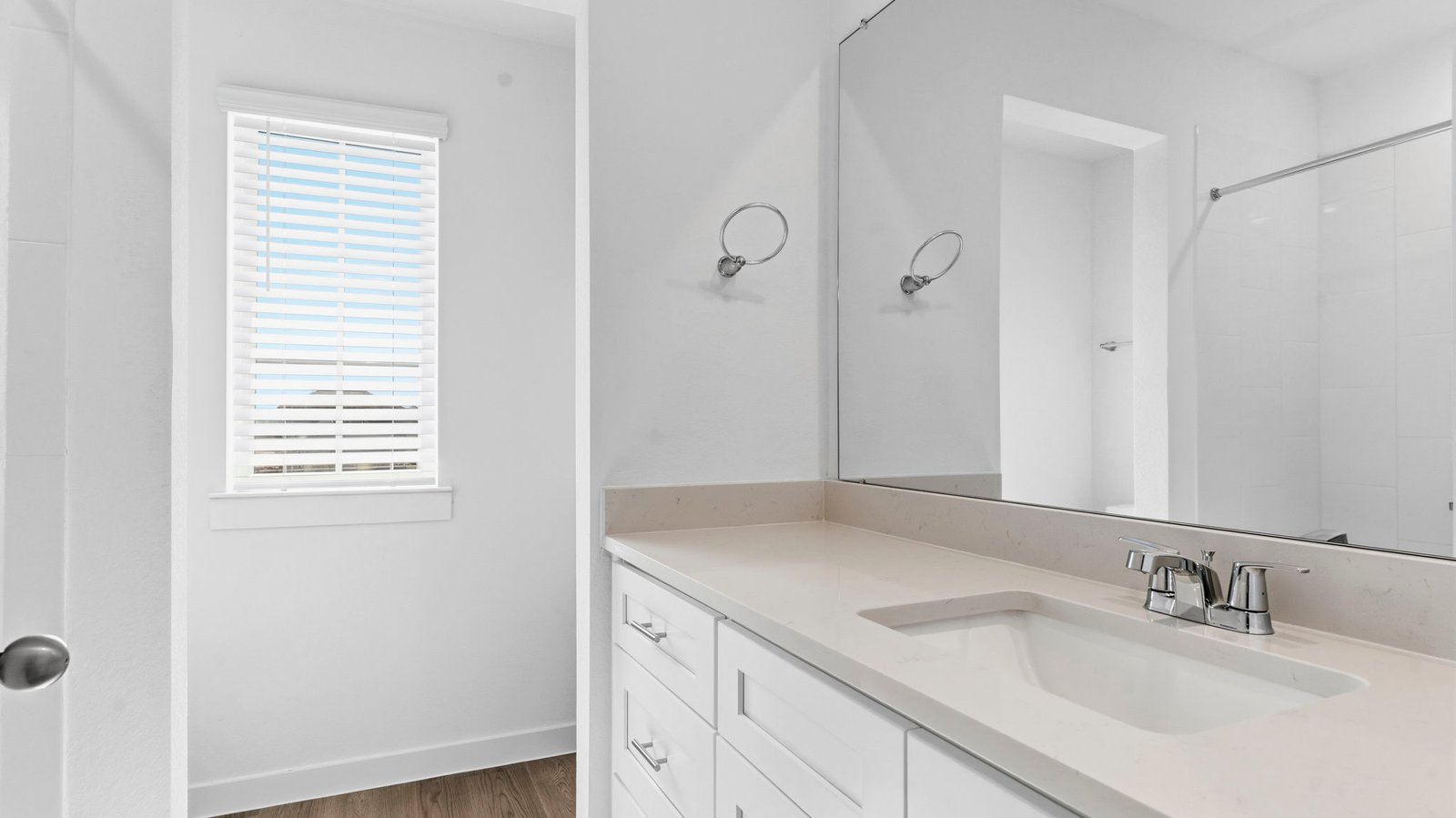 A well-designed bathroom equipped with quartz countertops, a standing tub, and a double vanity.