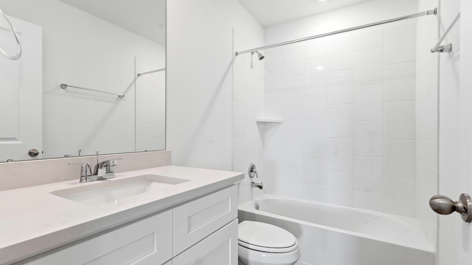 A well-designed bathroom equipped with quartz countertops, a standing tub, and a double vanity.