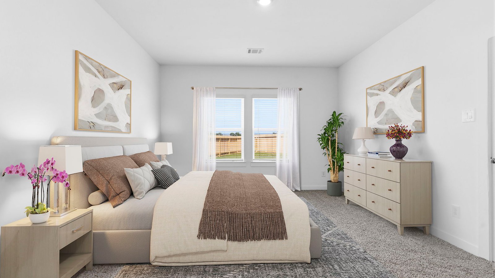 Primary bedroom with ceiling fan, plush carpeting, and a large walk-in closet.