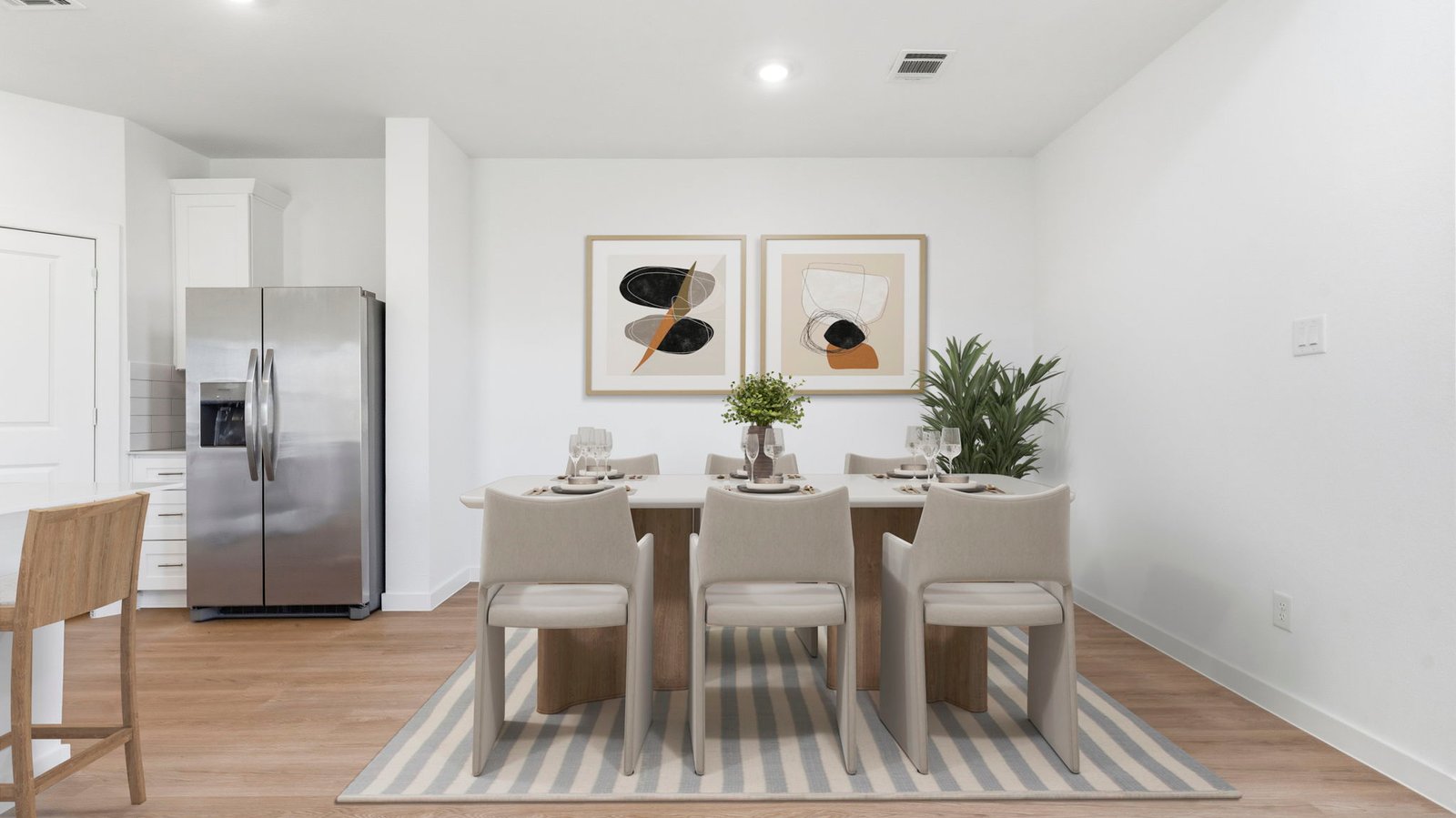 Spacious open concept dining area with vinyl wood flooring and access to the living and kitchen areas