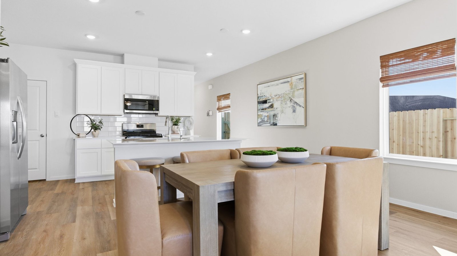 Spacious open concept dining area with vinyl wood flooring and access to the living and kitchen areas