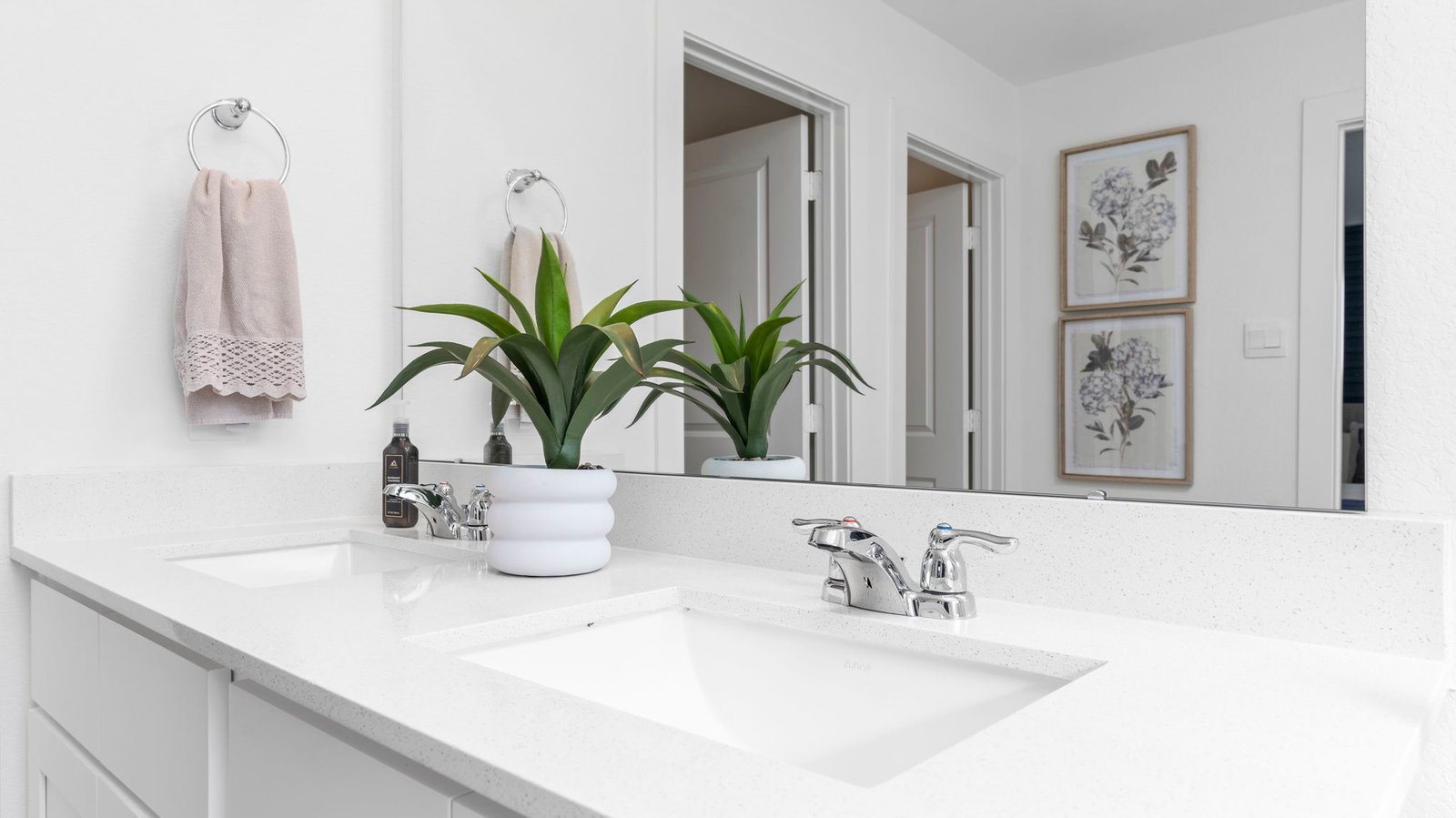 primary bathroom vanity with two windows