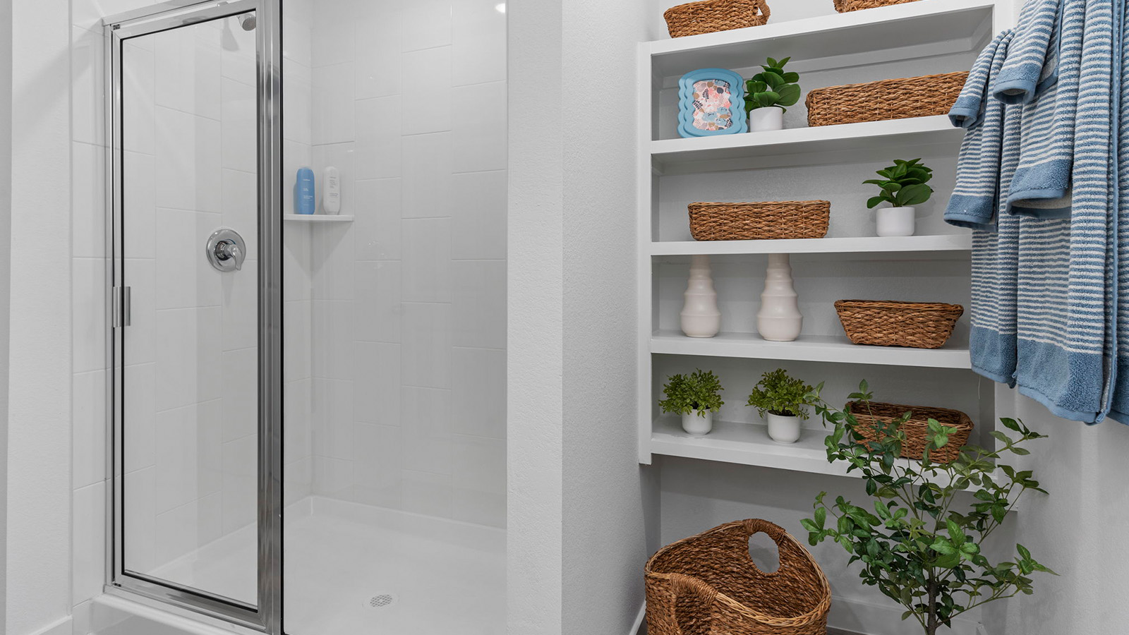 Primary bathroom with double sinks and standing shower