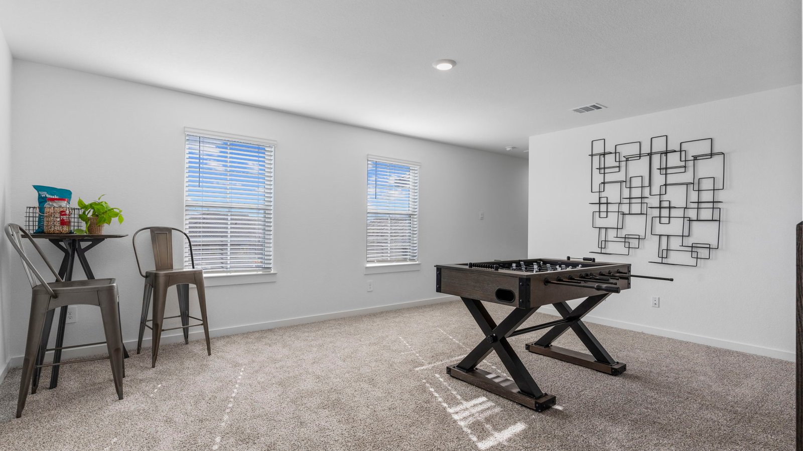 upstairs game room with two windows