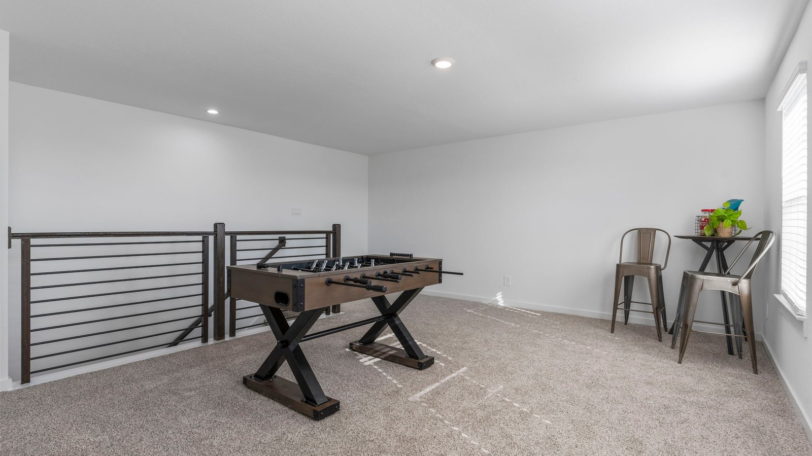 upstairs game room with two windows