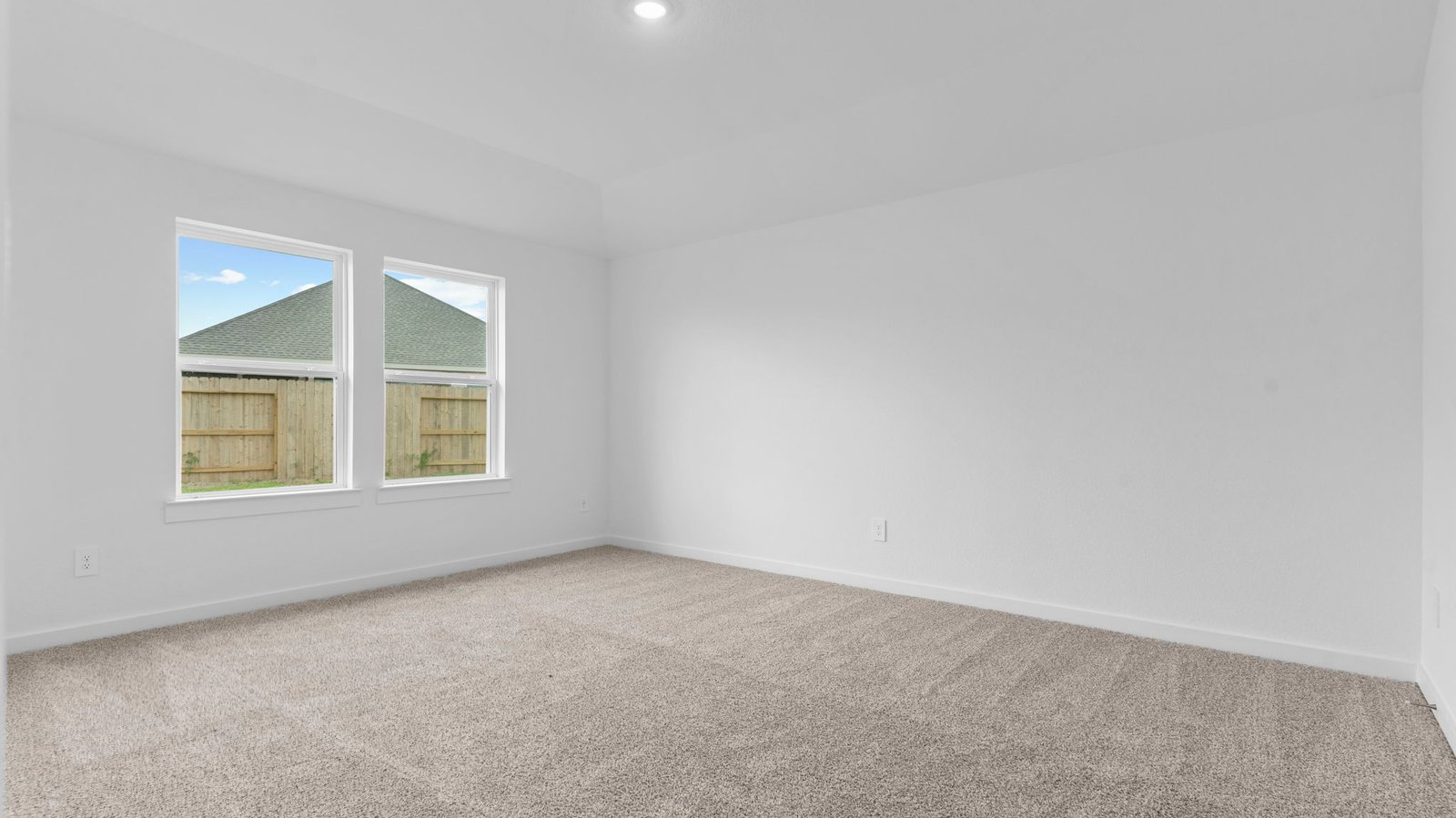 primary bedroom room with large window