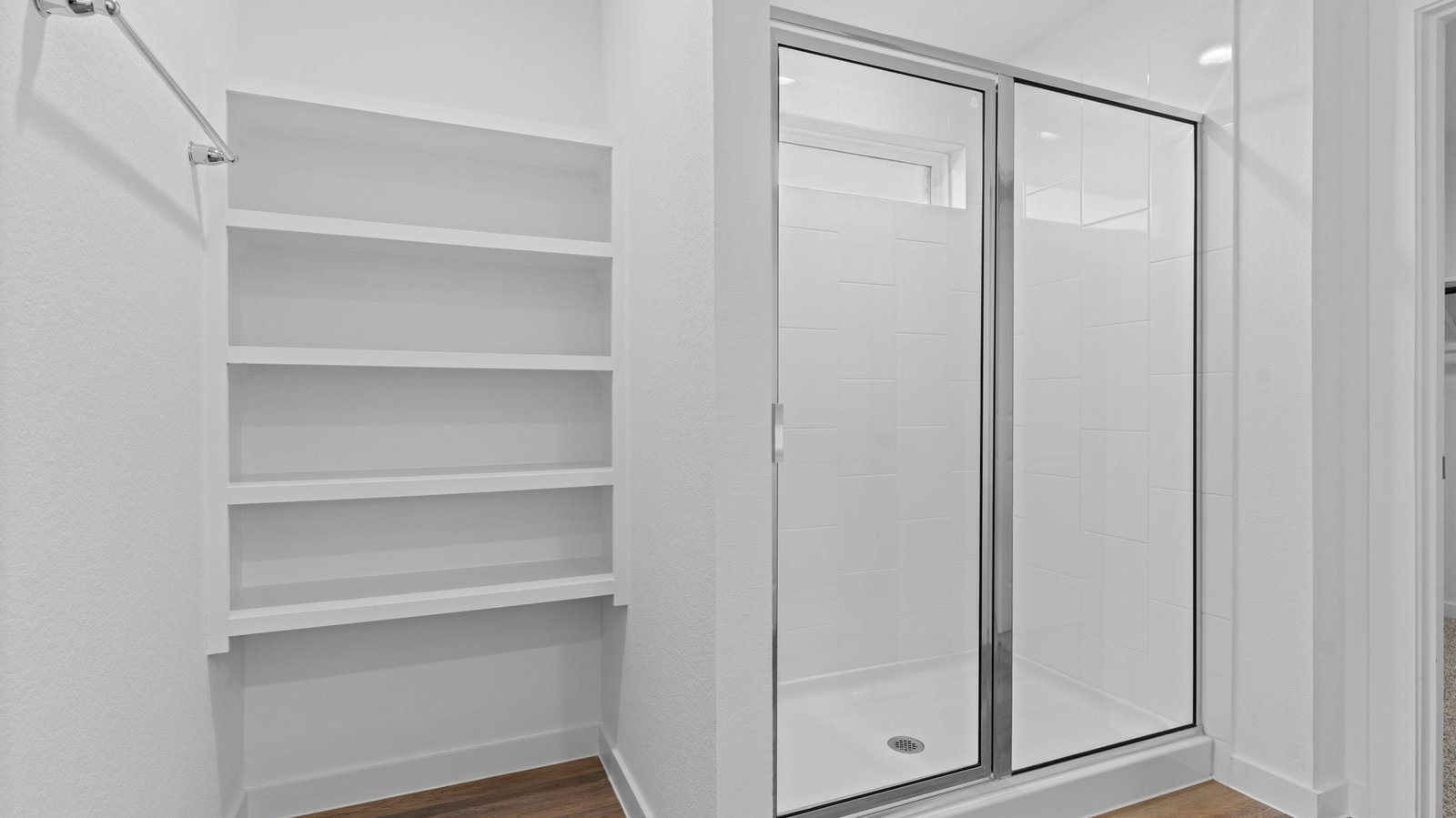 primary bathroom with open shelving and shower