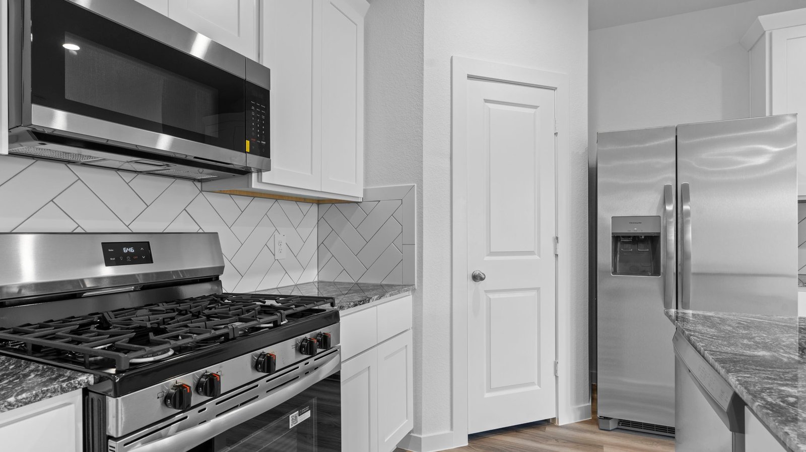 Bright and spacious kitchen with quartz countertops, stainless steel appliances, and an island with bar seating.