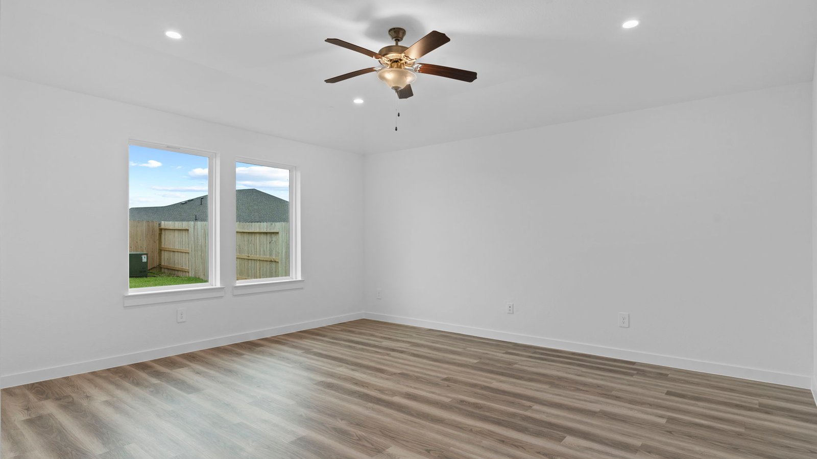 A well-organized living room that includes a kitchen and dining area, creating a warm and welcoming environment for gatherings.