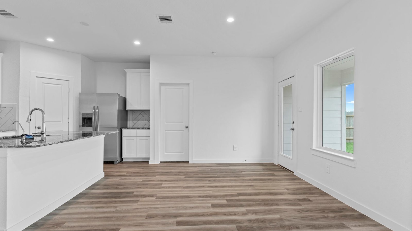 An open concept breakfast room with a large window.