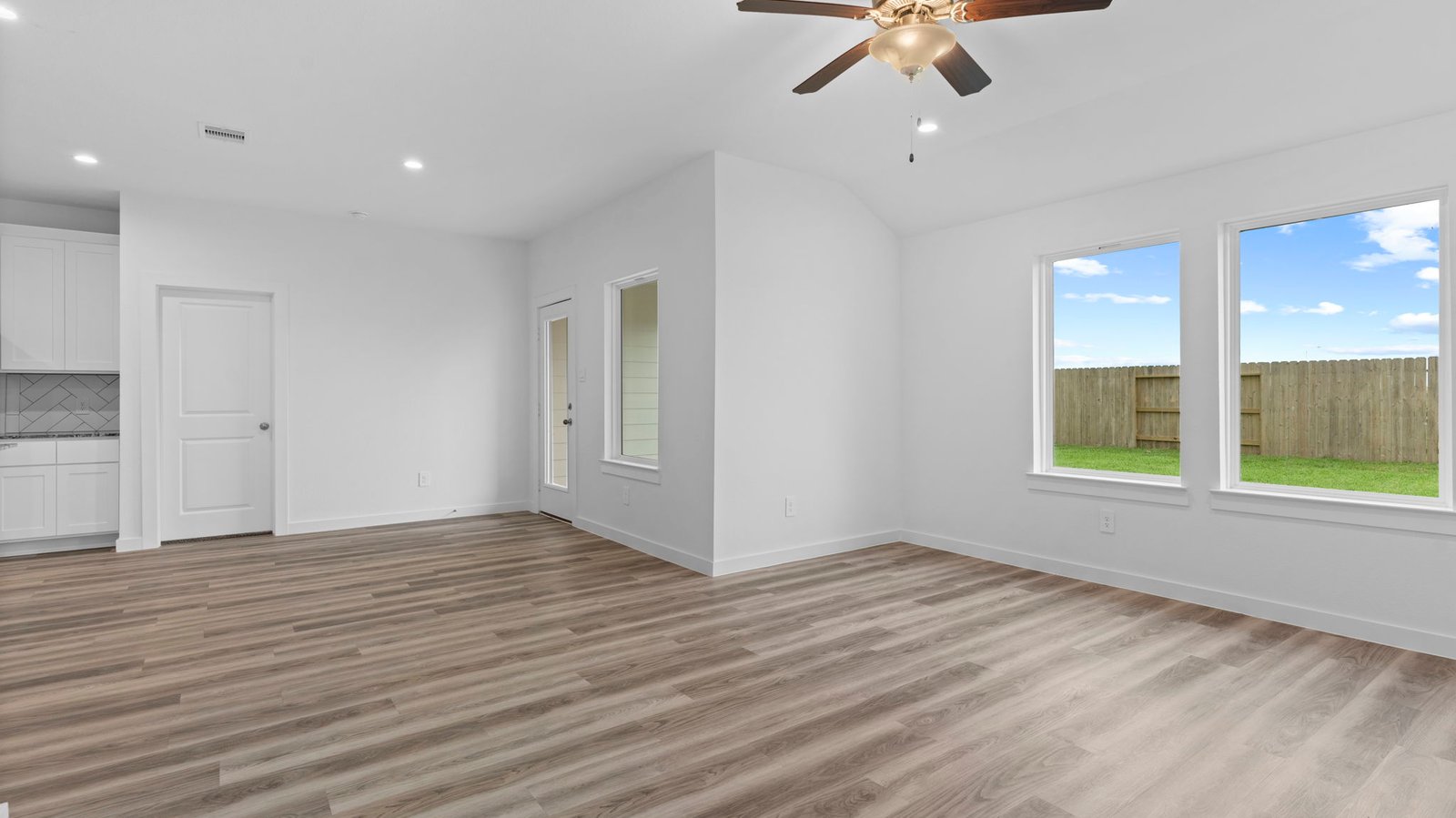 A well-organized living room that includes a kitchen and dining area, creating a warm and welcoming environment for gatherings.
