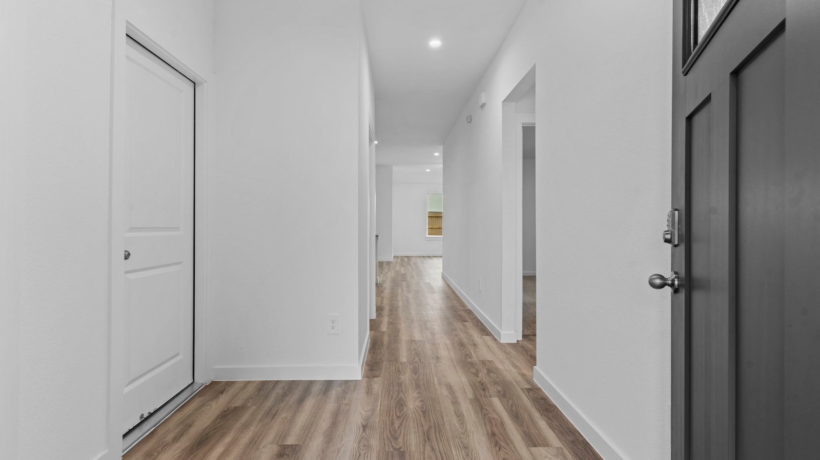 Entry hallway leading to living room and kitchen in the background.