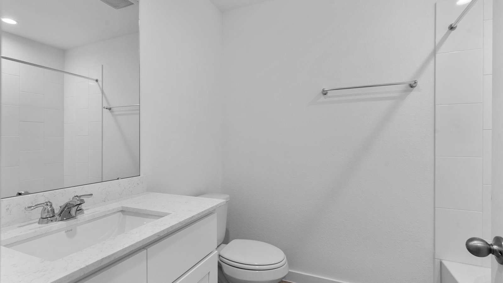 A well-designed bathroom equipped with quartz countertops, a standing tub, and a single vanity.