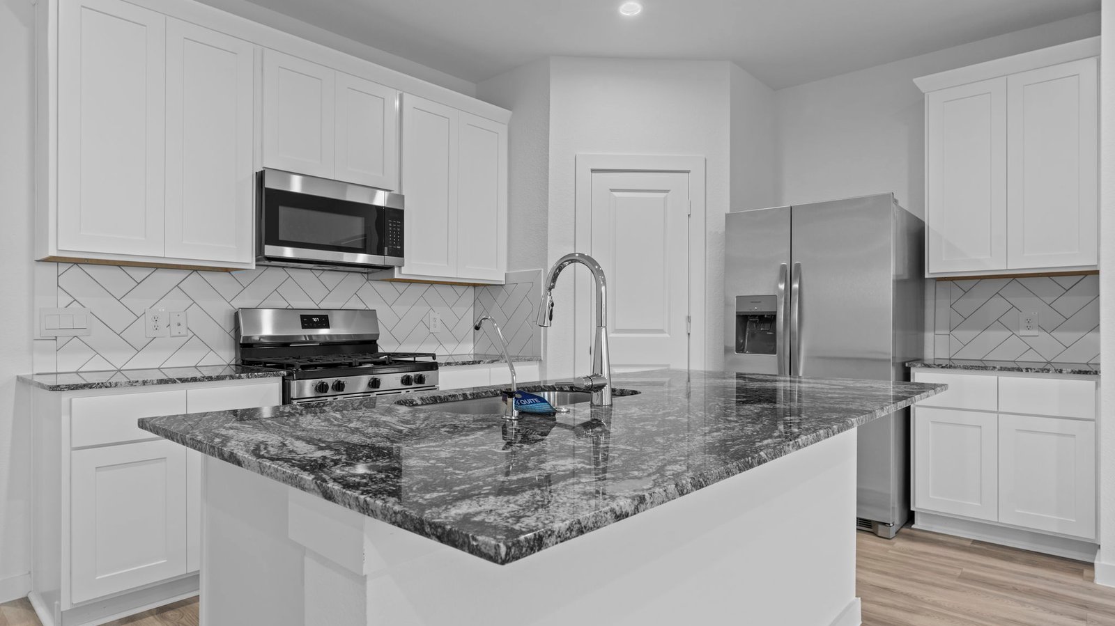 open concept kitchen with large island and walk in pantry