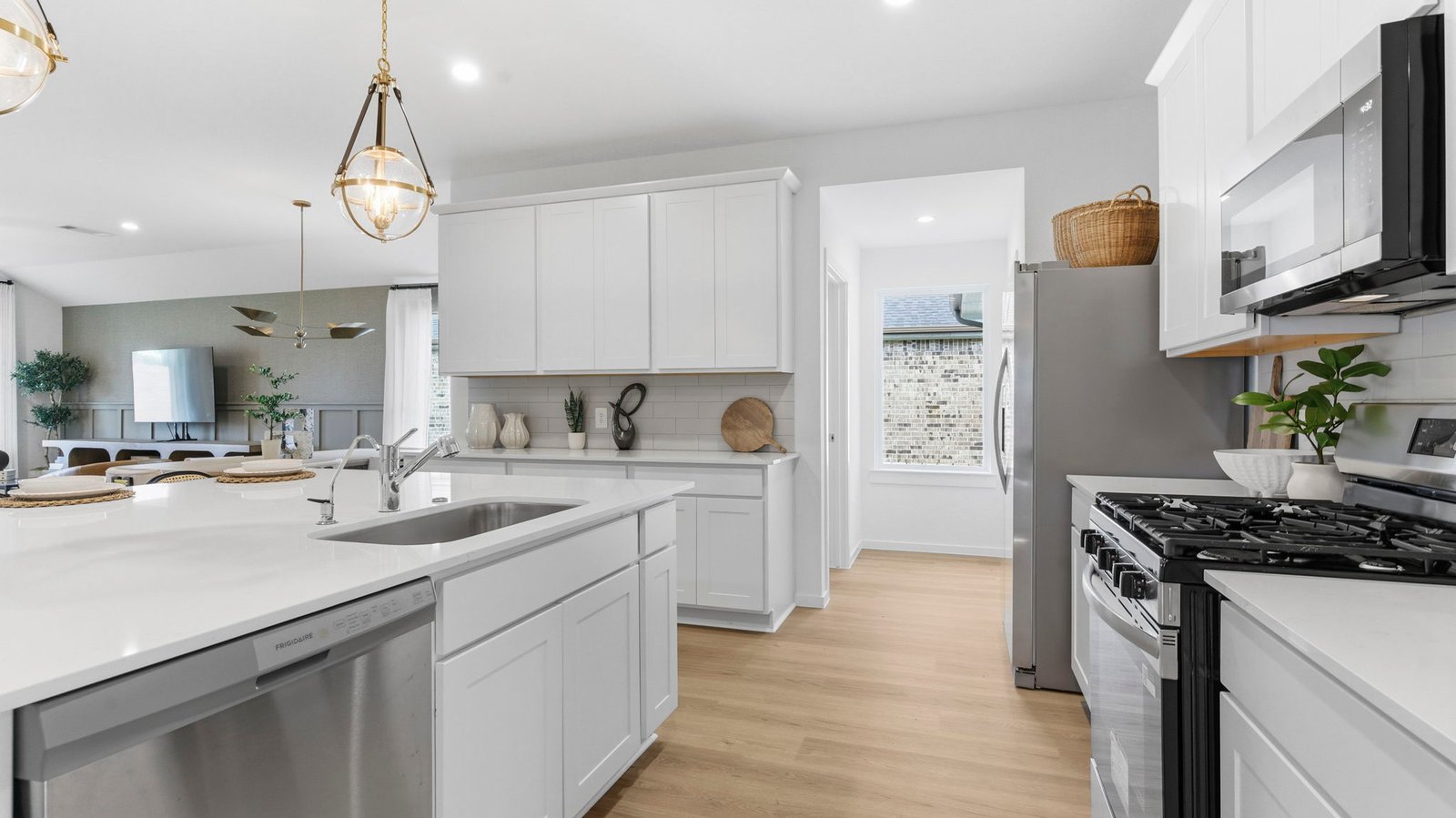 Bright and spacious kitchen with granite countertops, stainless steel appliances, and an island with bar seating.