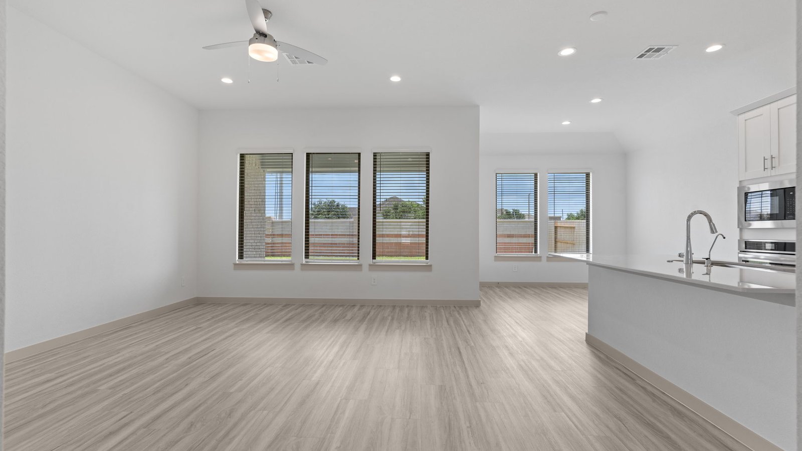 open concept kitchen and living room with multiple windows