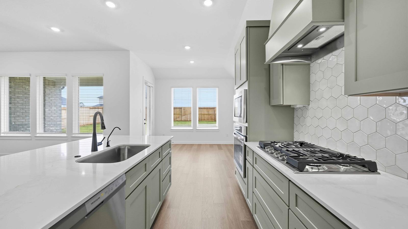Kitchen adorned with painted cabinets seamlessly integrated into an open dining area layout.