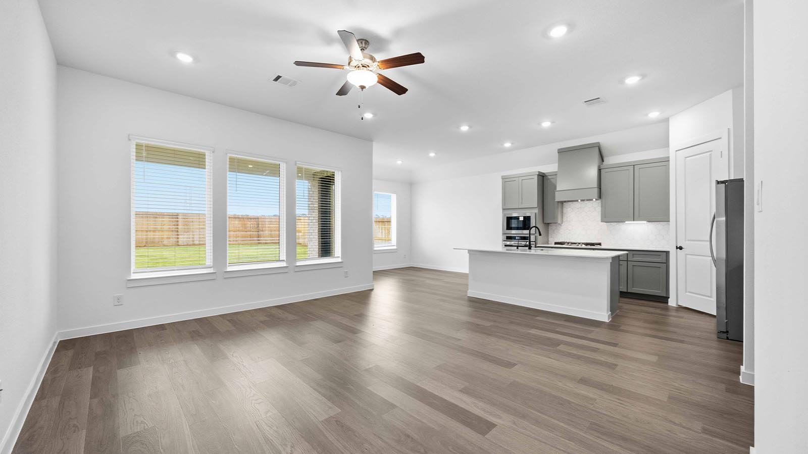 A well-organized living room that includes a kitchen and dining area, creating a warm and welcoming environment for gatherings.