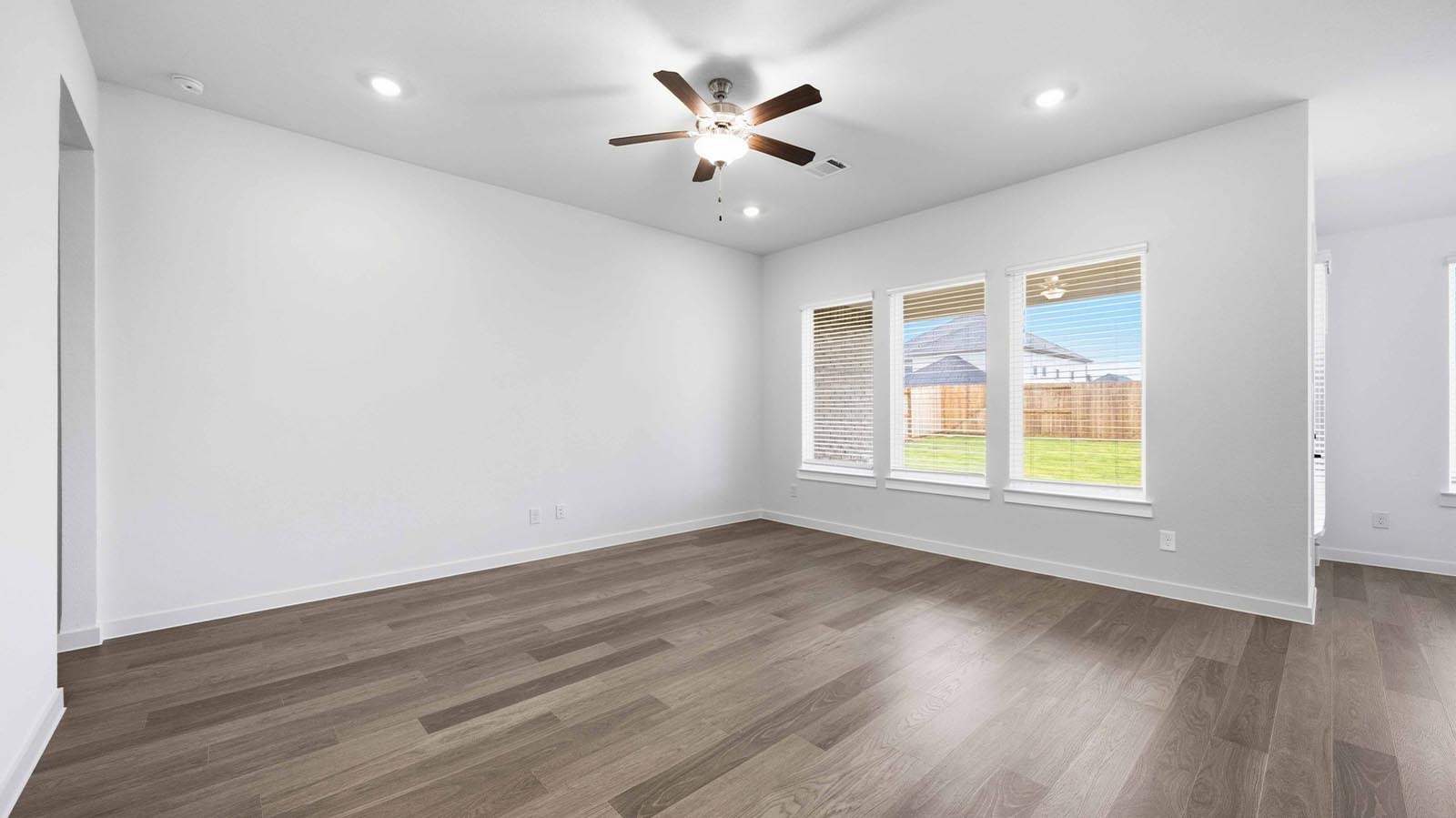A well-organized living room that includes a kitchen and dining area, creating a warm and welcoming environment for gatherings.