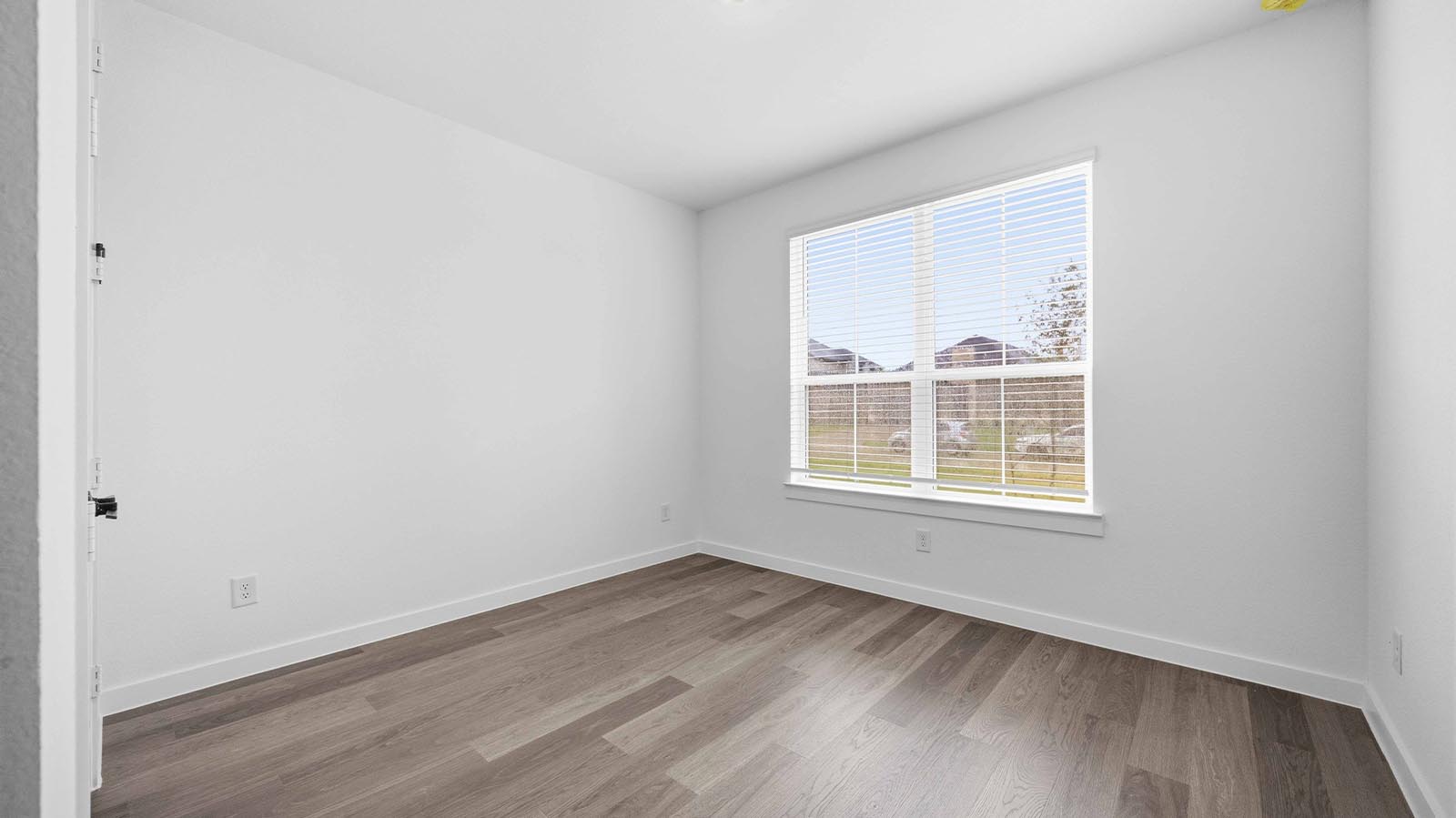 Comfortable guest bedroom featuring neutral-toned walls, carpeted flooring, and a separate closet.