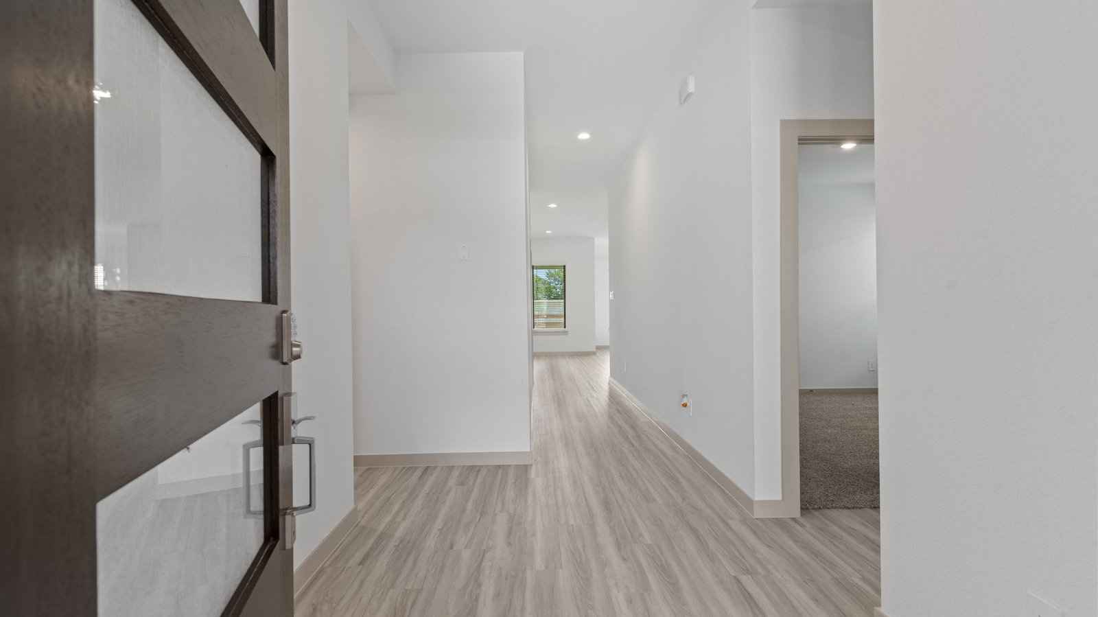 Foyer view of bedroom 4 and the hall leading to the family room.